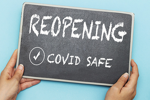 Reopening Covid Safe 'Reopening Covid Safe" written on a chalkboard